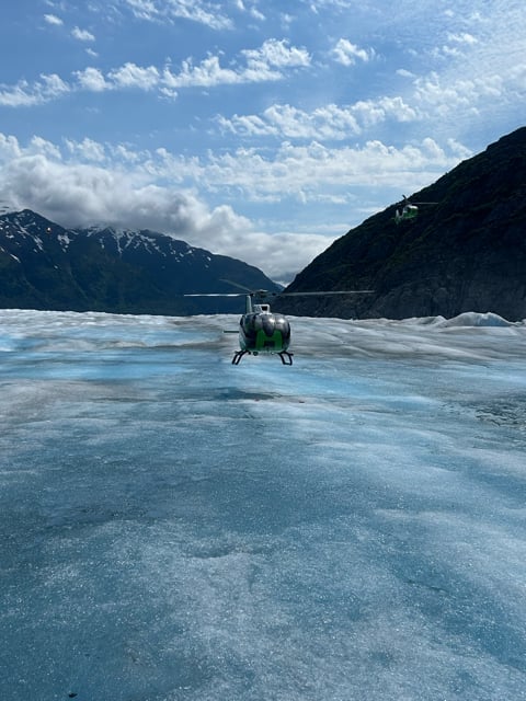 Alaska glacier winding between dark mountains