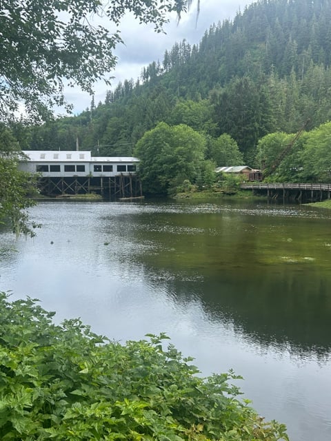 Alaska lodge reflected in a quiet forest lake