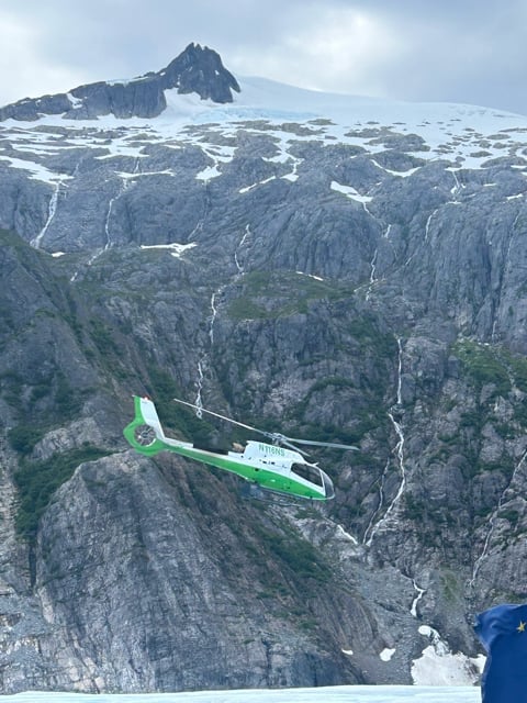 Helicopter flying through an Alaska glacier valley