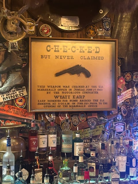 Historic Alaska saloon interior with mounted bear sign