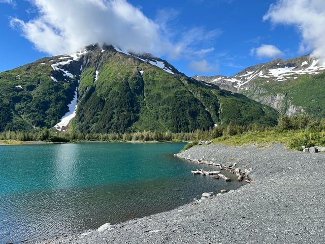 Mountain lake with kayaks along an Alaska shore