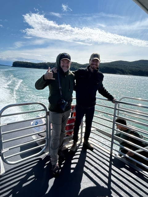People posing on a boat deck in Alaska