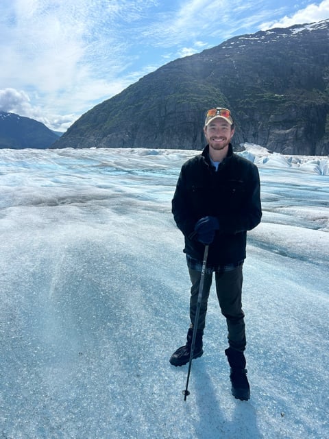 Person standing on a blue Alaska glacier
