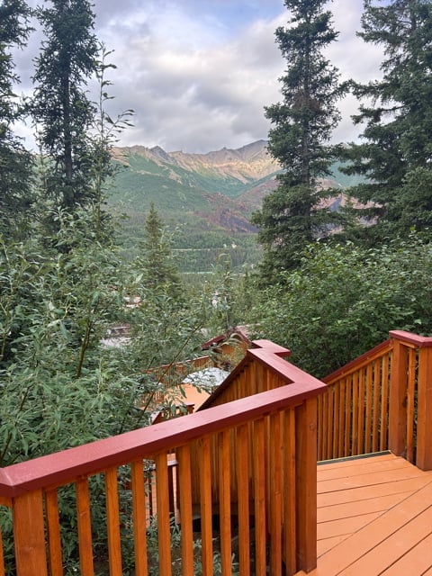 Wooden deck overlooking forested Alaska mountains