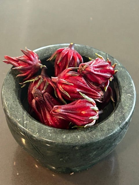 Bowl of harvested red roselle calyces