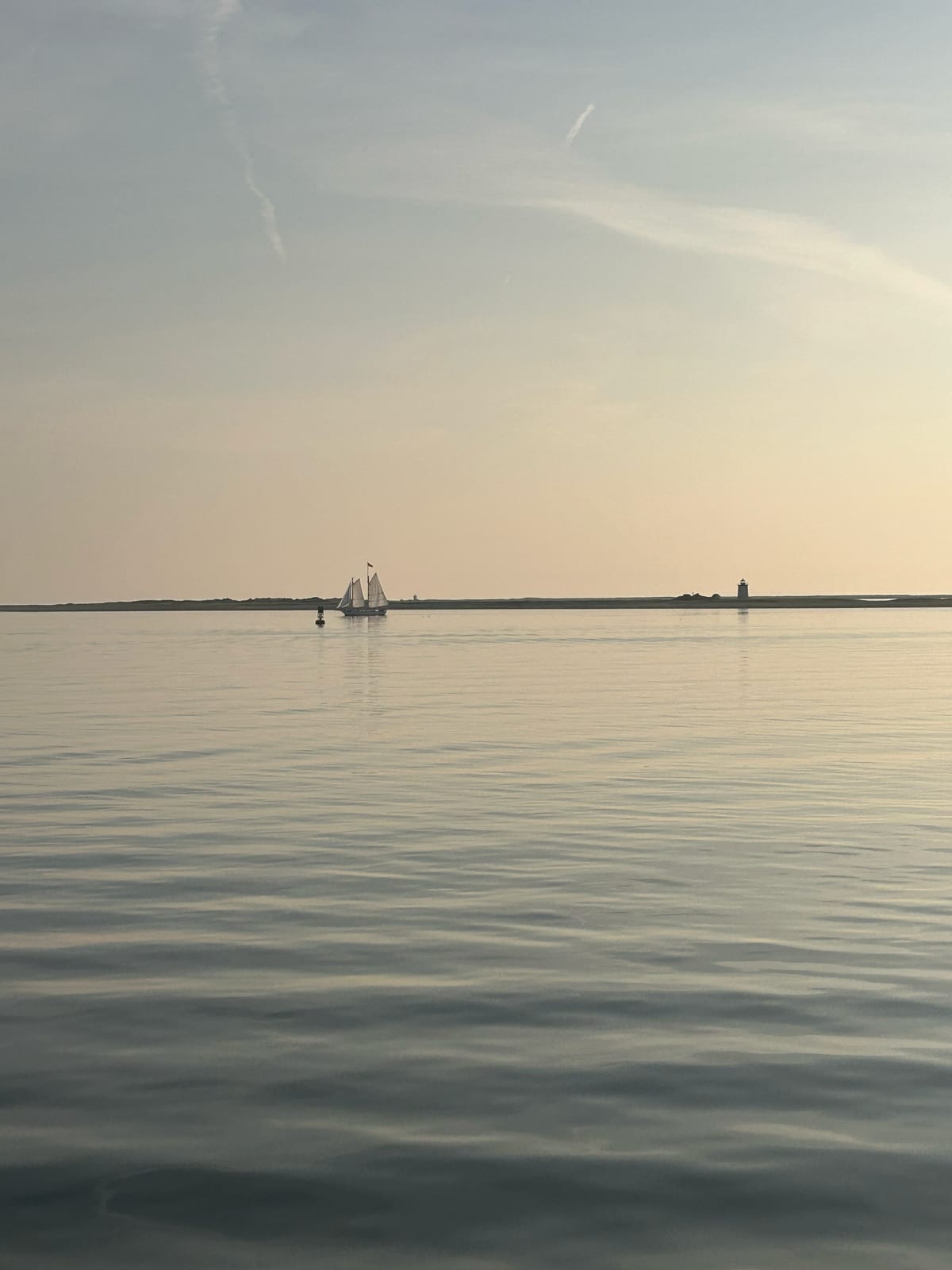 cape cod bay sailboat hazy sunset in Massachusetts