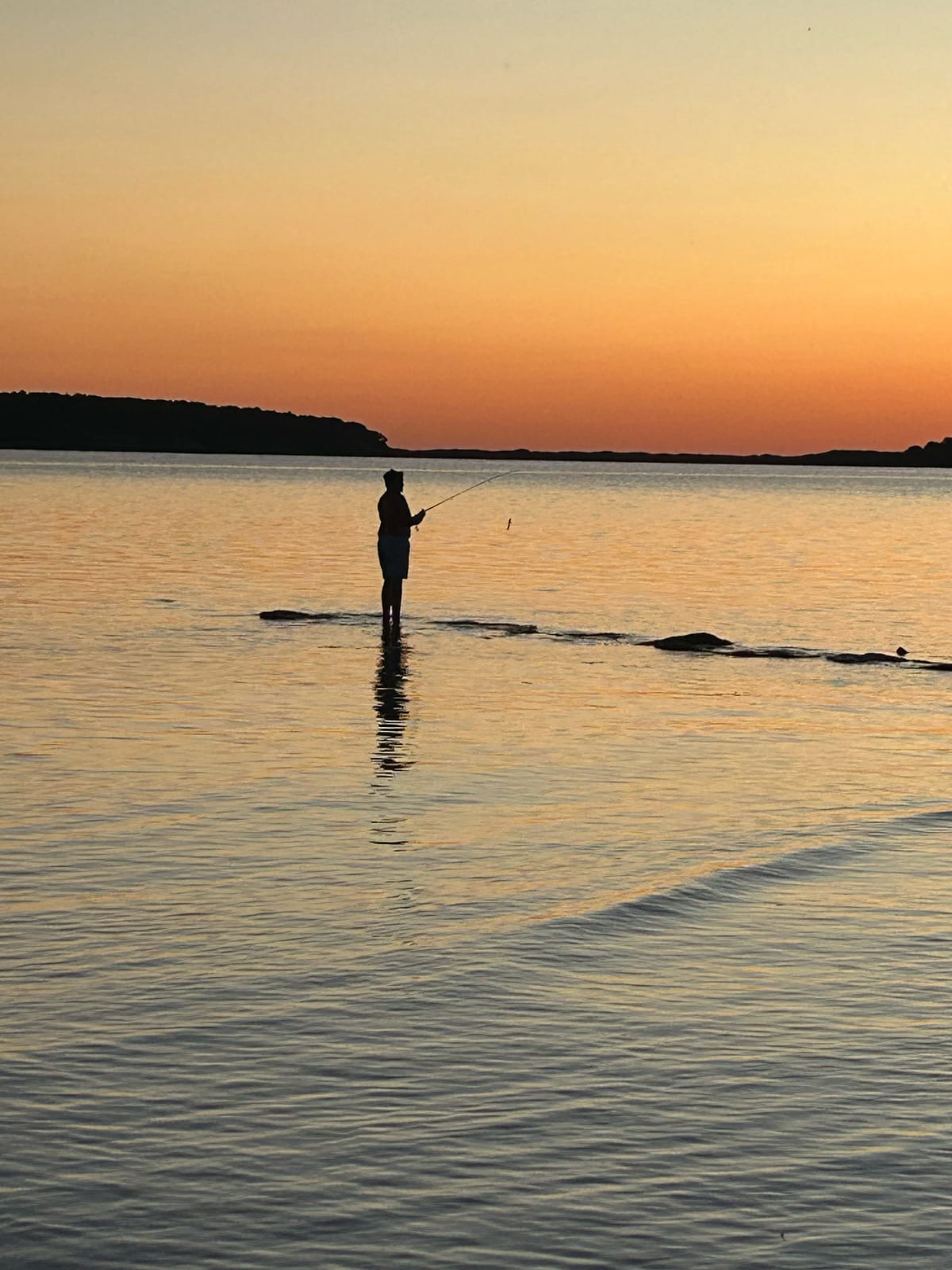 cape cod bay sunset lone paddleboarder in Massachusetts