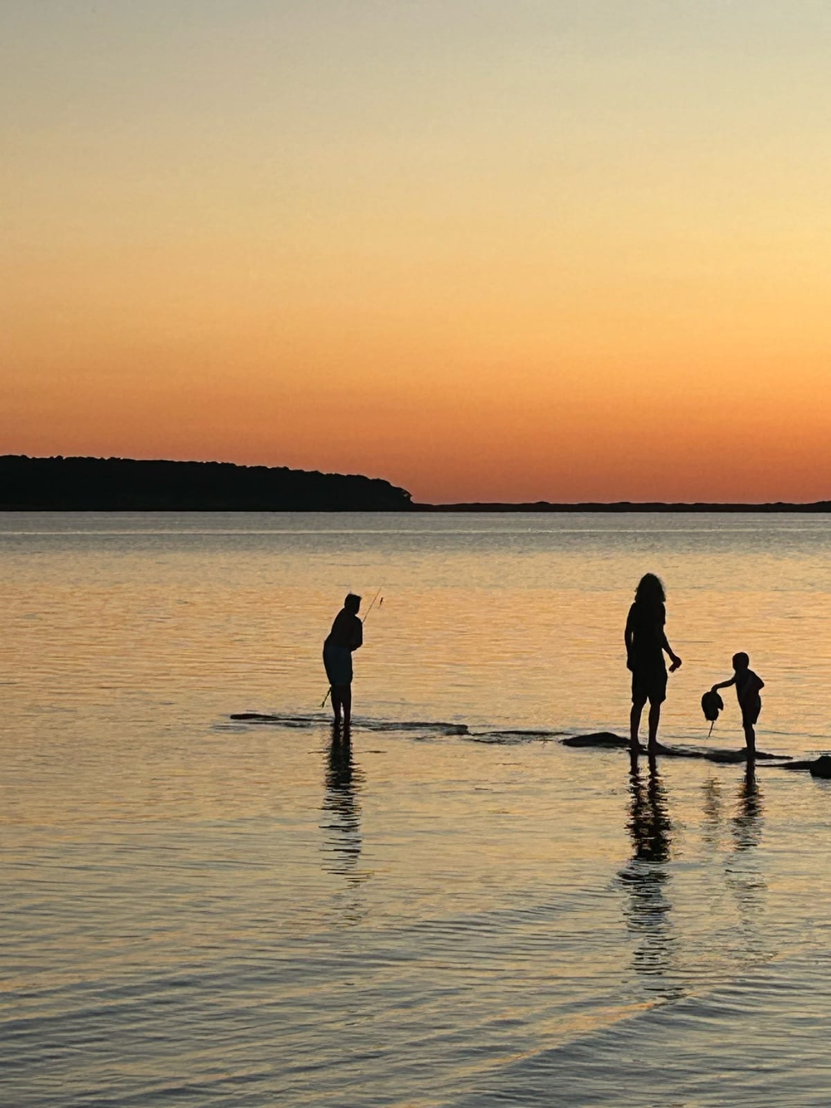 cape cod bay sunset paddleboarders silhouette in Massachusetts