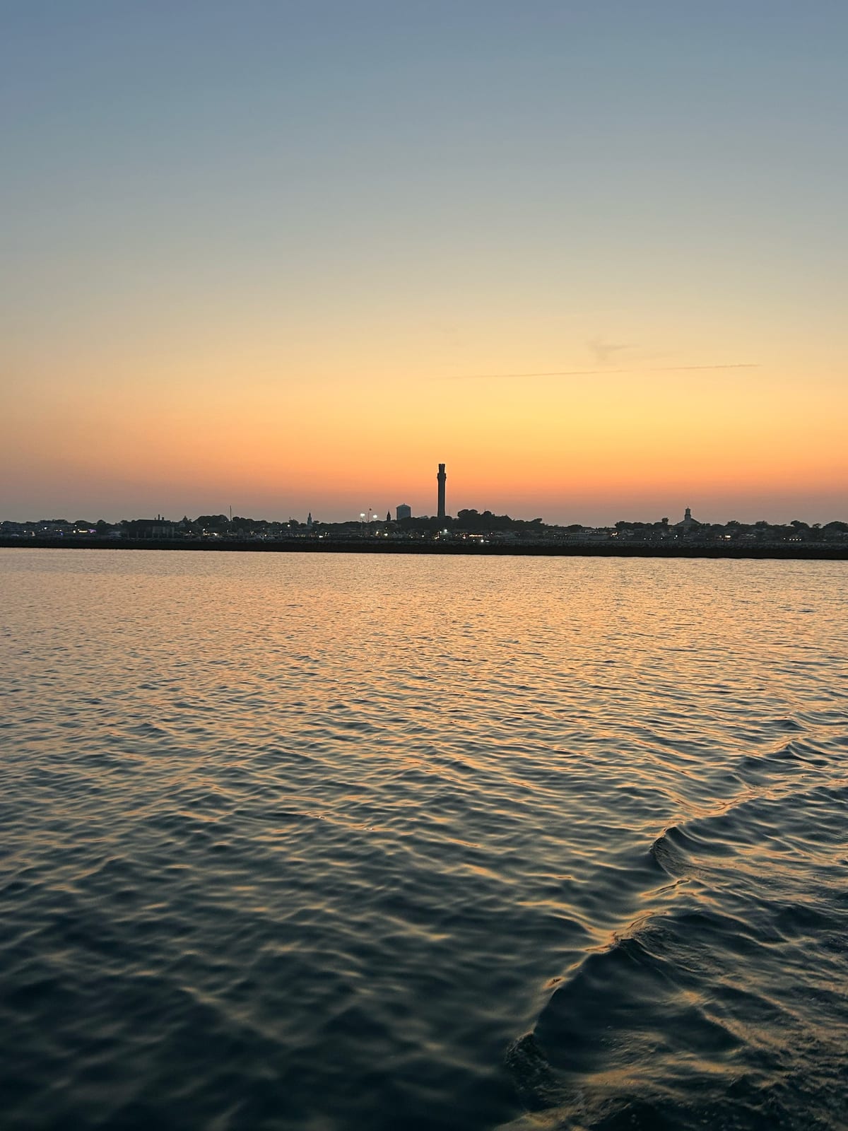 provincetown harbor sunset lighthouse golden in Massachusetts