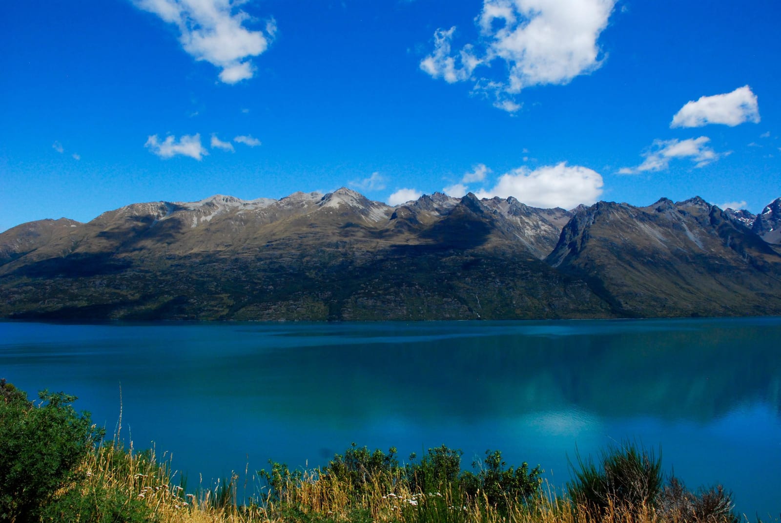 blue water mountain landscape Lake Wakatipu in New Zealand